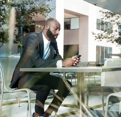 person sitting at a table on the phone